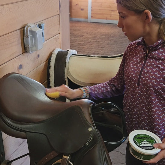 A video depicting Snowshoe Brand Leather Conditioner being applied to a horse saddle. 