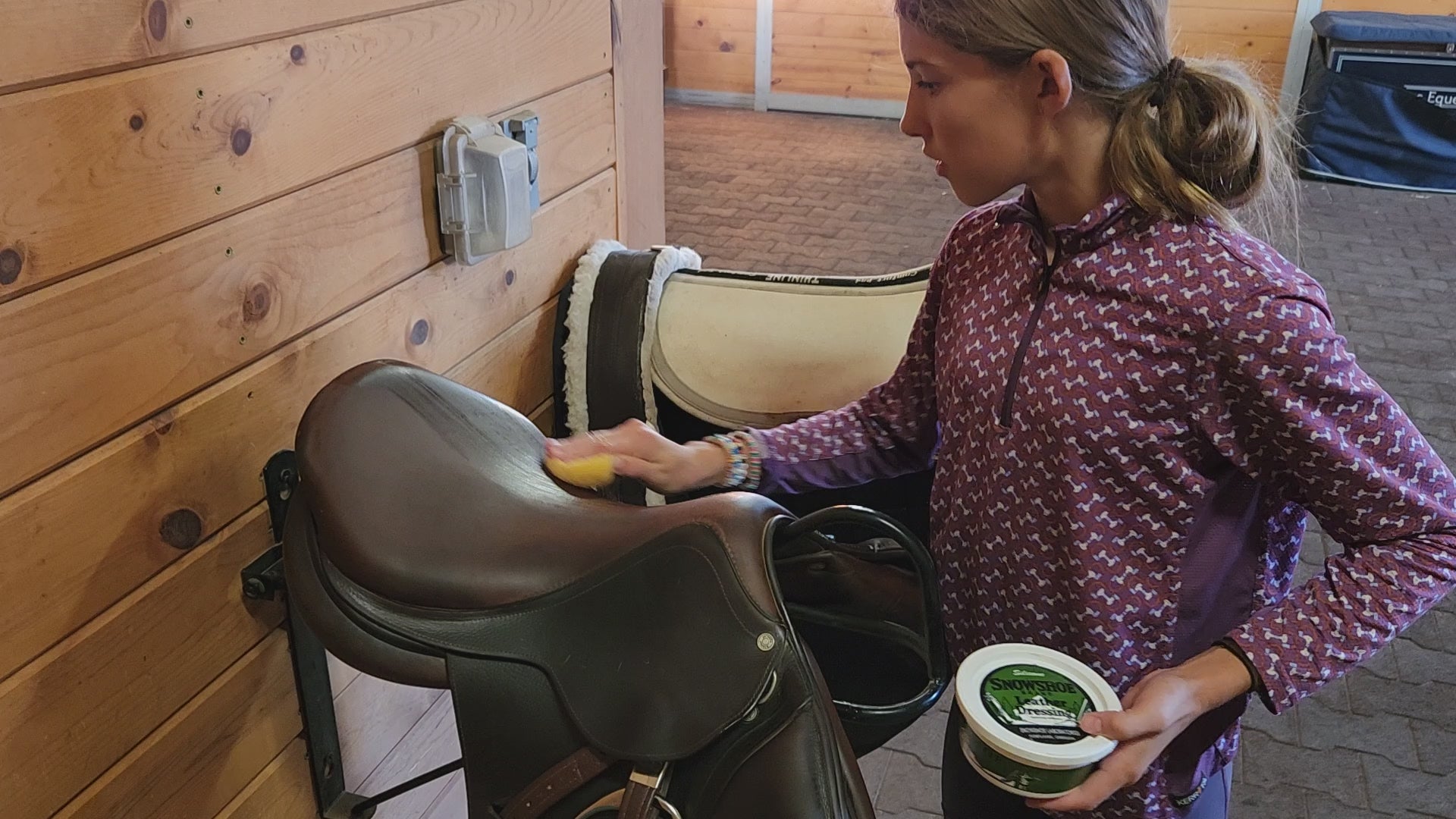 A video depicting Snowshoe Brand Leather Conditioner being applied to a horse saddle. 