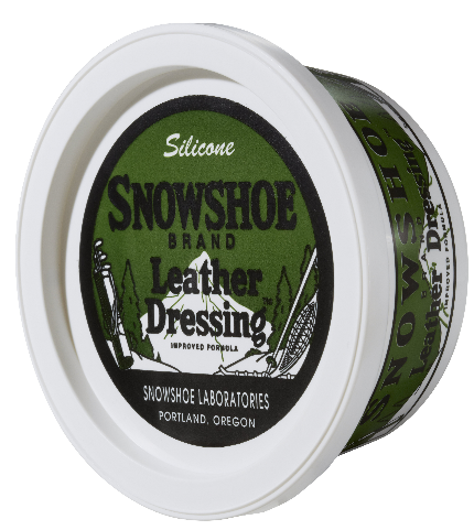 An 8oz tub of Snowshoe Brand Leather Conditioner is sitting on its side at an angle and displayed on a white background. 